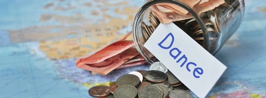 Money and dance on a table to illustrate a dancer's budget